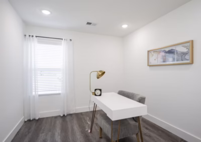 A clean white room set up as a home office