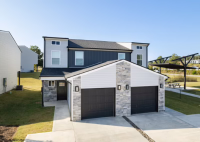 A cozy duplex with a combination of stone and plank siding.